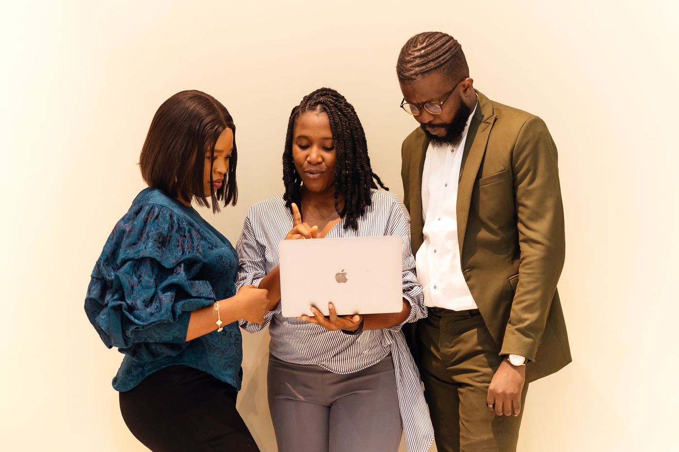 Three colleagues reviewing portfolio figures together
